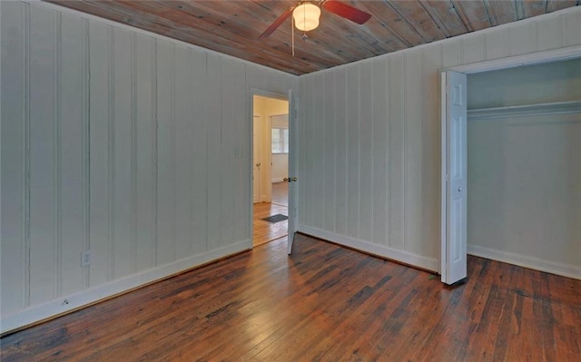 unfurnished bedroom with a closet, a ceiling fan, wooden ceiling, and wood-type flooring