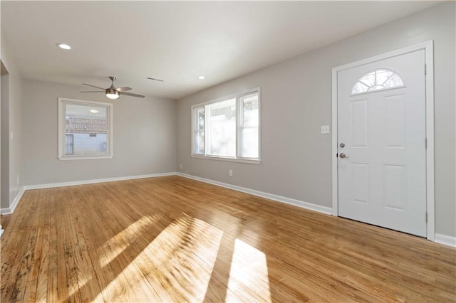 foyer featuring plenty of natural light, light wood-style flooring, baseboards, and ceiling fan