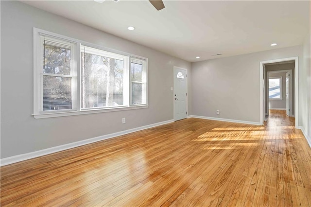 unfurnished living room with ceiling fan, light wood-style flooring, baseboards, and recessed lighting