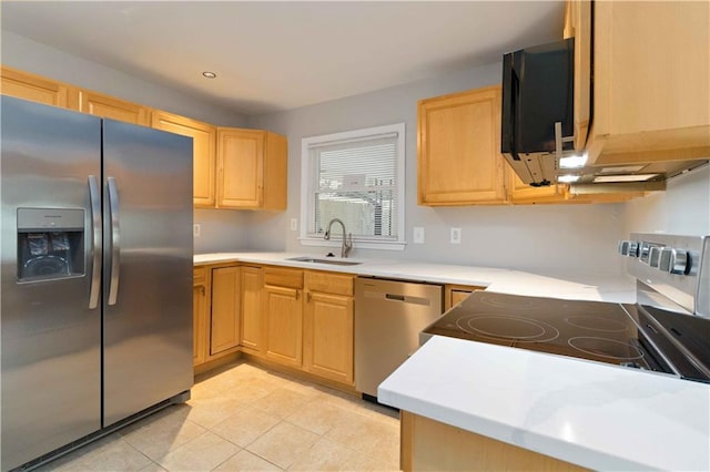 kitchen featuring light brown cabinetry, light tile patterned flooring, a sink, light countertops, and appliances with stainless steel finishes
