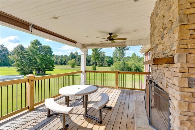 wooden terrace with a yard and ceiling fan