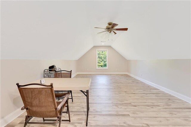 additional living space featuring light hardwood / wood-style floors, vaulted ceiling, and ceiling fan