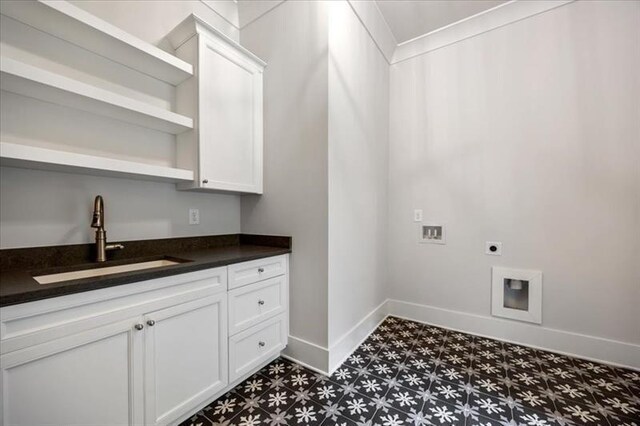 clothes washing area with tile patterned floors, hookup for an electric dryer, baseboards, washer hookup, and cabinet space