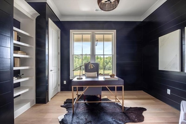 home office with light wood finished floors and crown molding