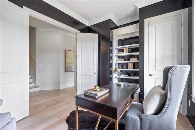 office with ornamental molding, light wood finished floors, and baseboards