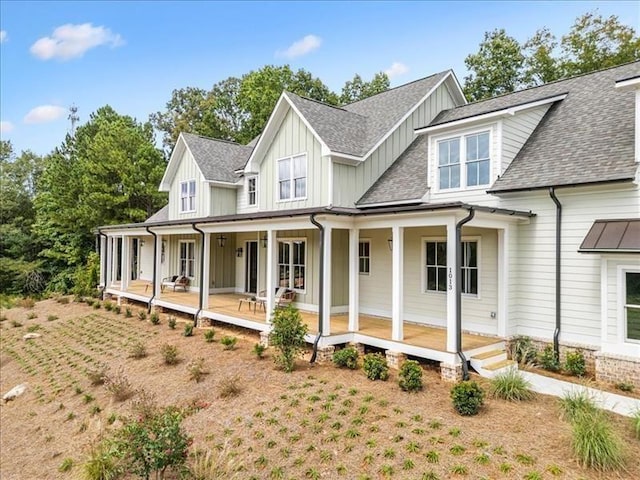 view of front facade featuring a porch, board and batten siding, and a shingled roof