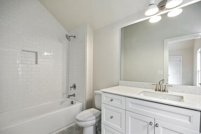 bathroom with toilet, bathtub / shower combination, vanity, vaulted ceiling, and tile patterned floors