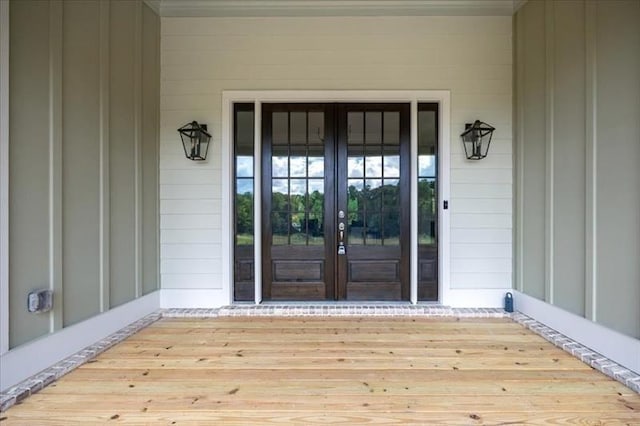doorway to property with french doors and board and batten siding