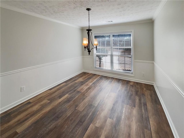 unfurnished dining area featuring a textured ceiling, a notable chandelier, dark wood-type flooring, baseboards, and crown molding