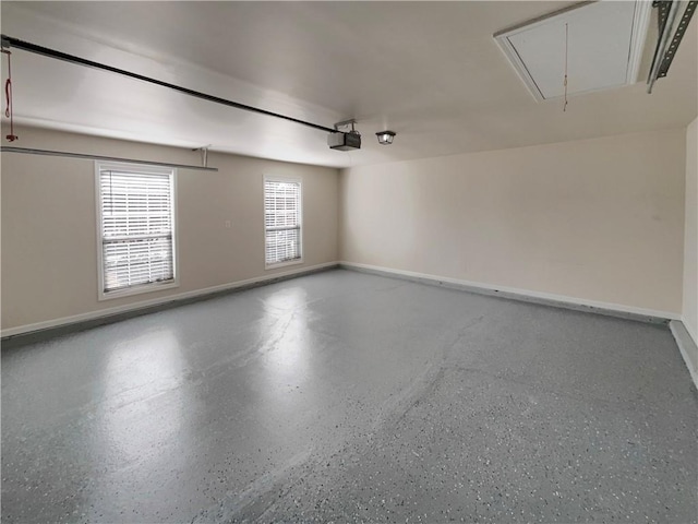 garage featuring a garage door opener and baseboards