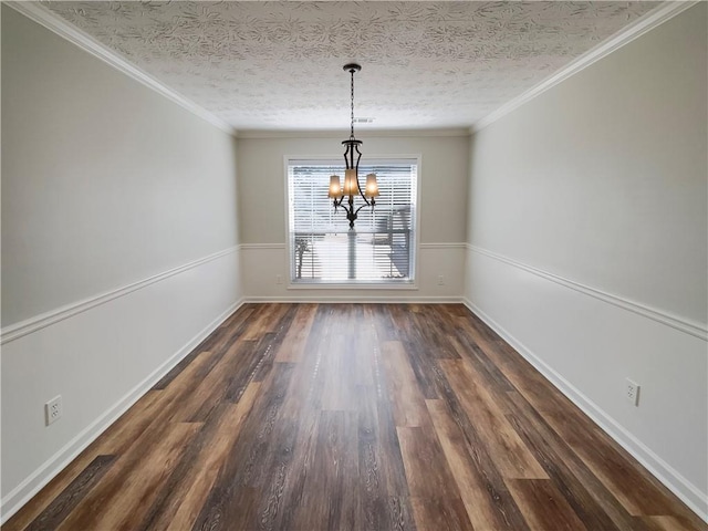 unfurnished dining area featuring a textured ceiling, ornamental molding, dark wood finished floors, and a notable chandelier