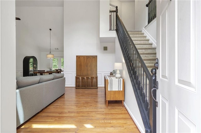 1867 N Creek Cir, Alpharetta, GA 30009 - foyer featuring a towering ceiling, light wood finished floors, stairs, and wainscoting