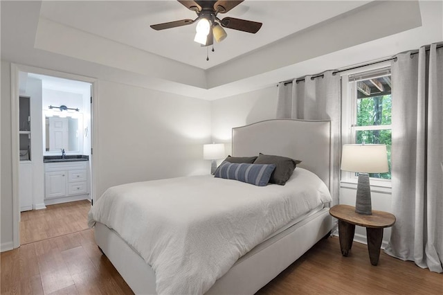 1867 N Creek Cir, Alpharetta, GA 30009 - bedroom with light wood-style floors, a sink, a raised ceiling, and ensuite bathroom