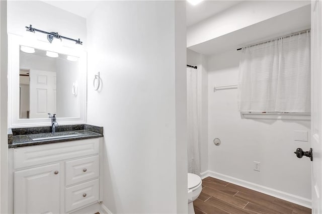 1867 N Creek Cir, Alpharetta, GA 30009 - bathroom featuring vanity, baseboards, wood finished floors, and toilet