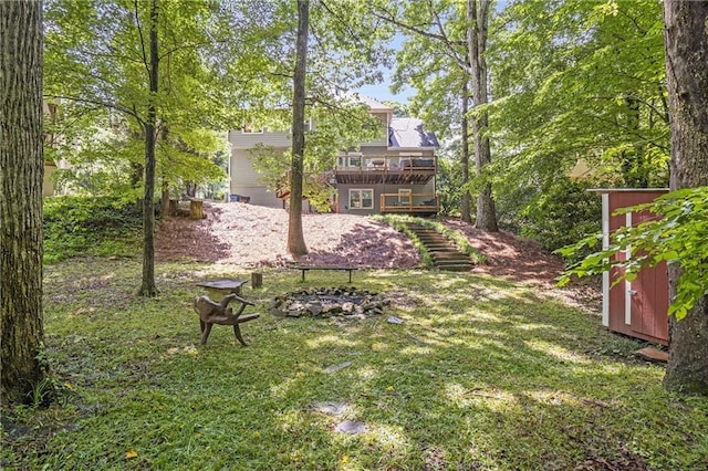 1867 N Creek Cir, Alpharetta, GA 30009 - view of grassy yard with stairs, a wooden deck, and a fire pit