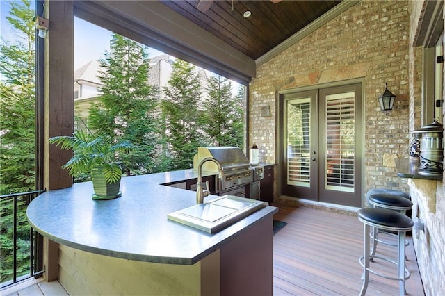 wooden deck featuring french doors, grilling area, and area for grilling