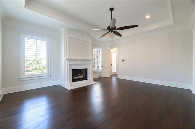 unfurnished living room with a premium fireplace, baseboards, dark wood finished floors, and crown molding