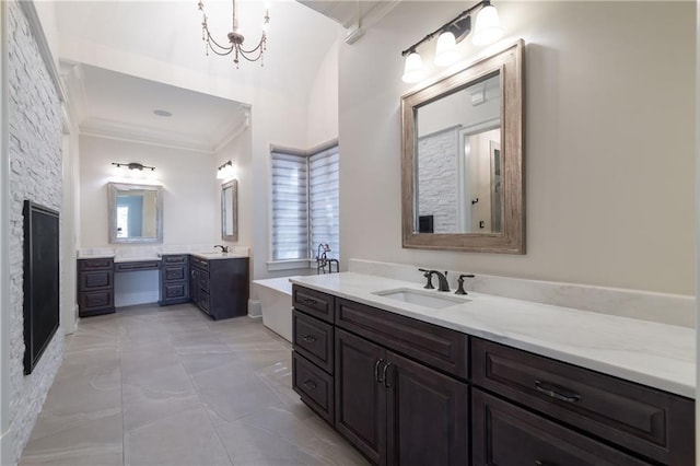 full bathroom featuring crown molding, two vanities, a sink, and a tub