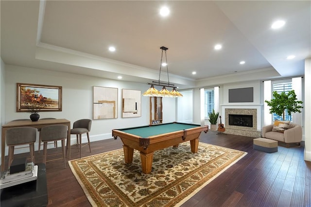 playroom featuring a tray ceiling, dark wood finished floors, and crown molding