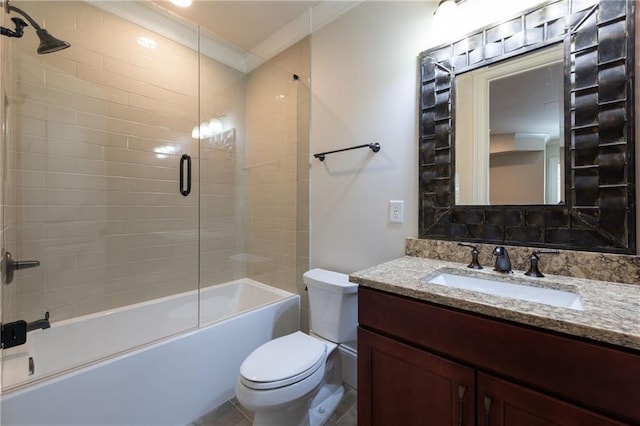 bathroom with ornamental molding, enclosed tub / shower combo, vanity, and toilet