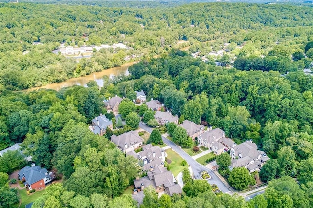 aerial view featuring a water view, a wooded view, and a residential view