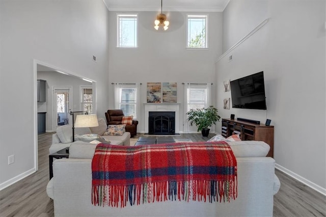 living room featuring ornamental molding, a wealth of natural light, and wood-type flooring