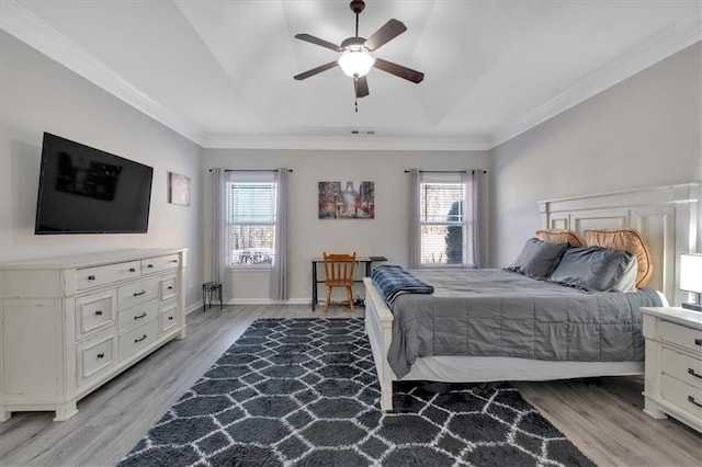 bedroom with ceiling fan, ornamental molding, and light hardwood / wood-style floors