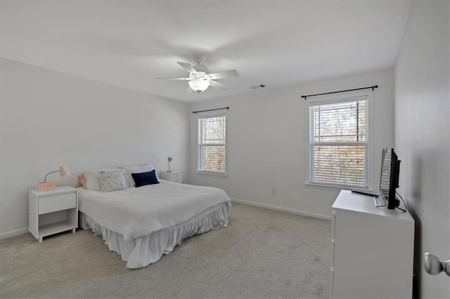 carpeted bedroom featuring multiple windows and ceiling fan