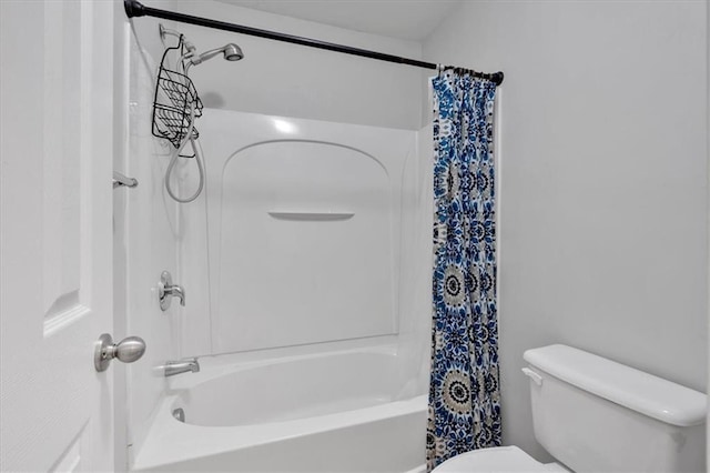 bathroom with shower / bath combo and toilet