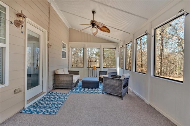 sunroom with ceiling fan and lofted ceiling