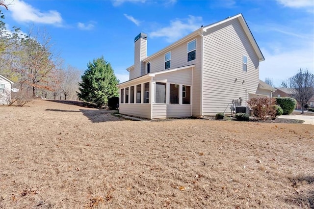 rear view of property with a sunroom