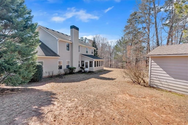 view of property exterior with a sunroom