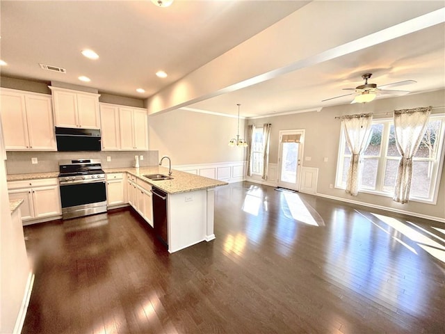 kitchen featuring kitchen peninsula, stainless steel gas range, dishwasher, white cabinetry, and sink