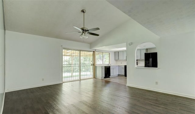 unfurnished living room with dark wood-style floors, ceiling fan, baseboards, and high vaulted ceiling