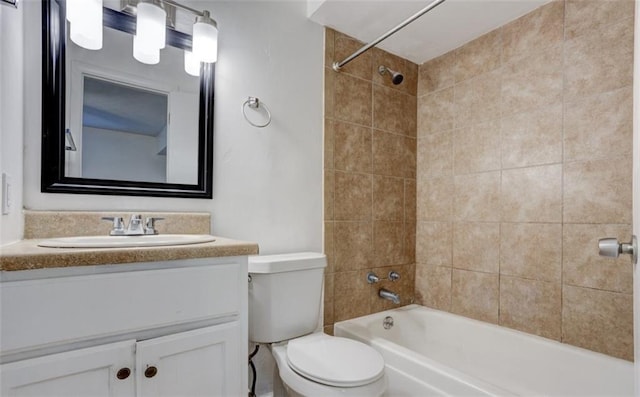 bathroom featuring toilet, bathing tub / shower combination, and vanity