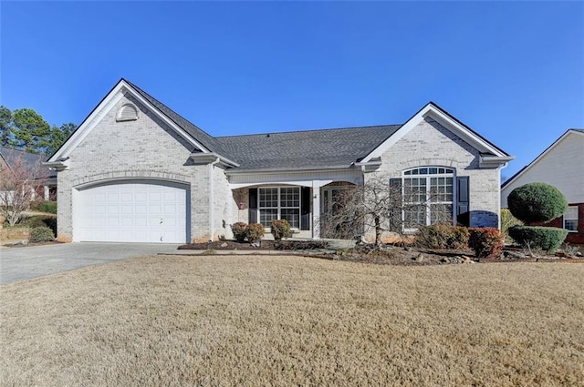 french country home featuring brick siding, a shingled roof, a front yard, a garage, and driveway