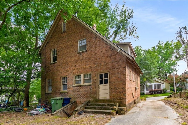 1200 Mansfield Ave NE, Atlanta, GA 30307 - view of property exterior featuring entry steps, brick siding, a chimney, and concrete driveway