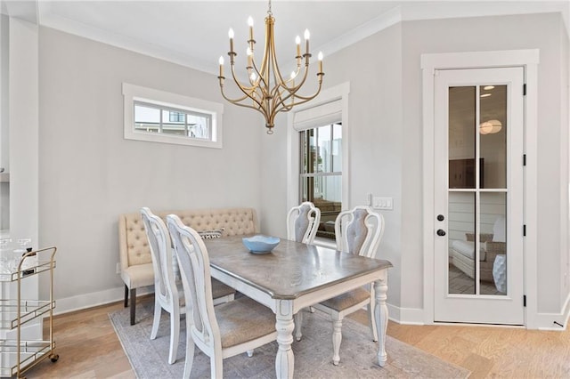 1010 Fendley St, Woodstock, GA 30188 - dining room featuring a chandelier, light wood-style floors, crown molding, and baseboards