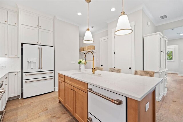 1010 Fendley St, Woodstock, GA 30188 - kitchen with white appliances, crown molding, light wood finished floors, a sink, and light stone countertops