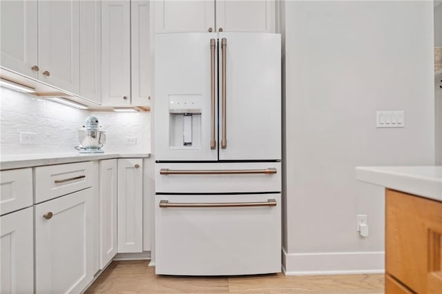 1010 Fendley St, Woodstock, GA 30188 - kitchen with high end white fridge, white cabinets, backsplash, light countertops, and baseboards