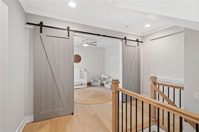 1010 Fendley St, Woodstock, GA 30188 - corridor with a barn door, wood finished floors, an upstairs landing, and recessed lighting