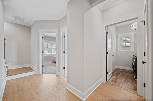 1010 Fendley St, Woodstock, GA 30188 - hall with independent washer and dryer, light wood-style flooring, and baseboards