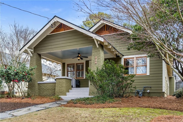 craftsman inspired home with ceiling fan and covered porch