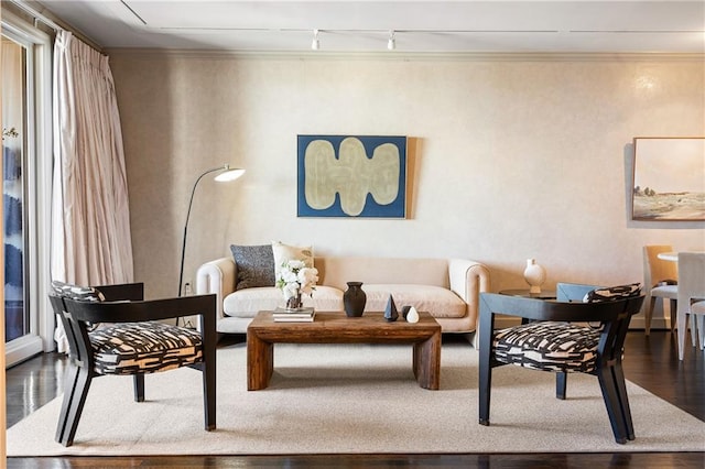 living room featuring hardwood / wood-style floors, crown molding, and rail lighting