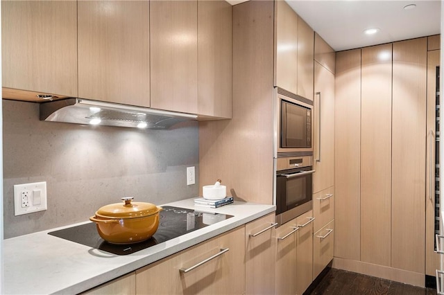 kitchen with built in microwave, stainless steel oven, light brown cabinetry, and custom range hood