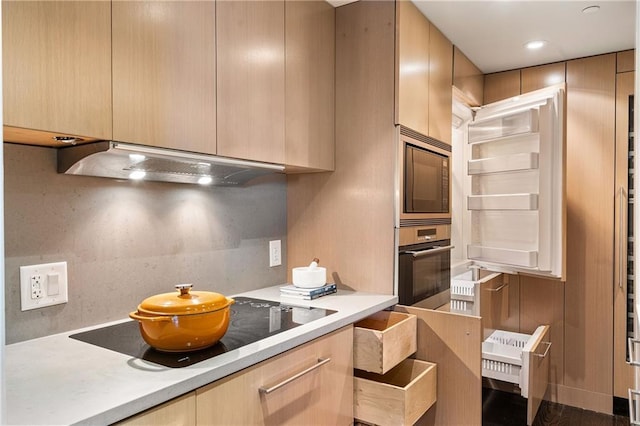 kitchen with light brown cabinetry, custom exhaust hood, and appliances with stainless steel finishes