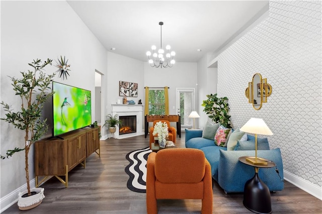 sitting room featuring dark wood-type flooring and a chandelier