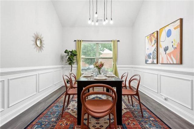 dining room featuring dark hardwood / wood-style floors and lofted ceiling