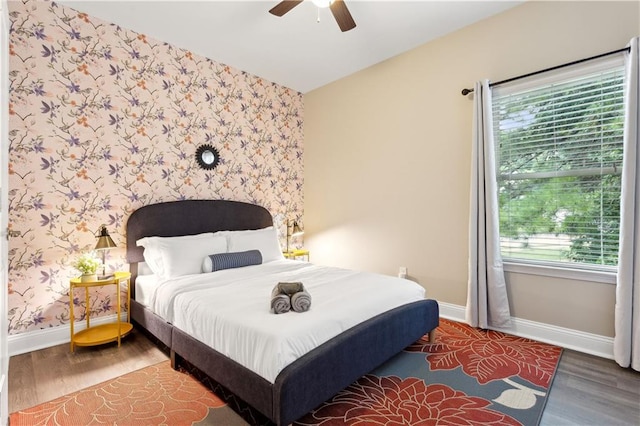 bedroom with dark hardwood / wood-style flooring and ceiling fan