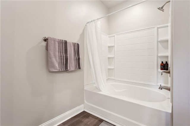 bathroom with hardwood / wood-style flooring and shower / tub combo